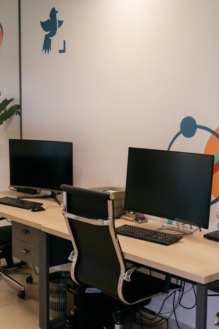 Mastering the First Impression: Your intriguing post title goes here Empty modern office space with two desks, monitors, and stylish chairs.